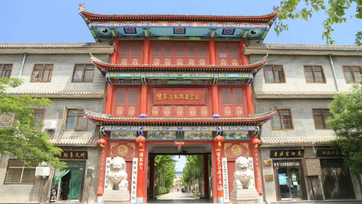 A red and gold school entrance between two campus wings.