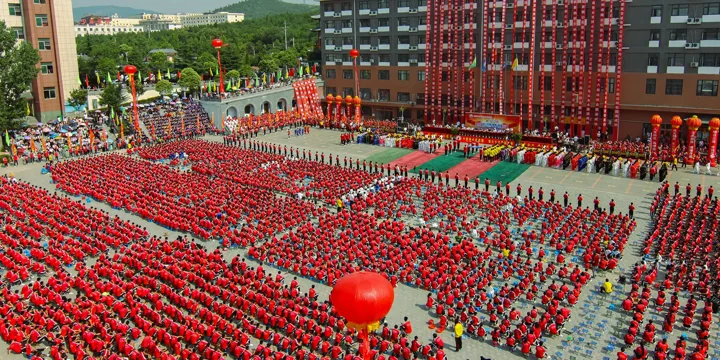 Students in red uniforms assemble in the academy courtyard.