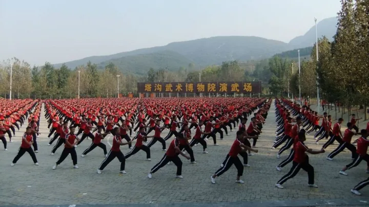 Rows of students practise in the training centre’s outdoor square.
