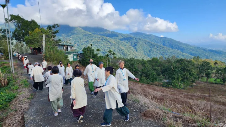 White-clad retreat participants practise walking meditation at Leshan.