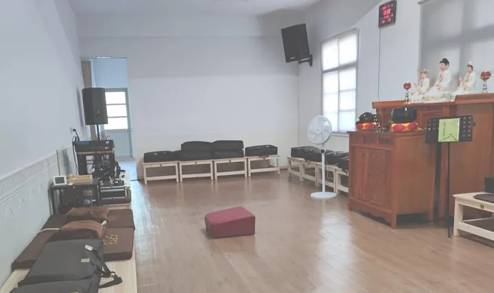 Meditation cushions and an altar inside Pumen Meditation Centre.
